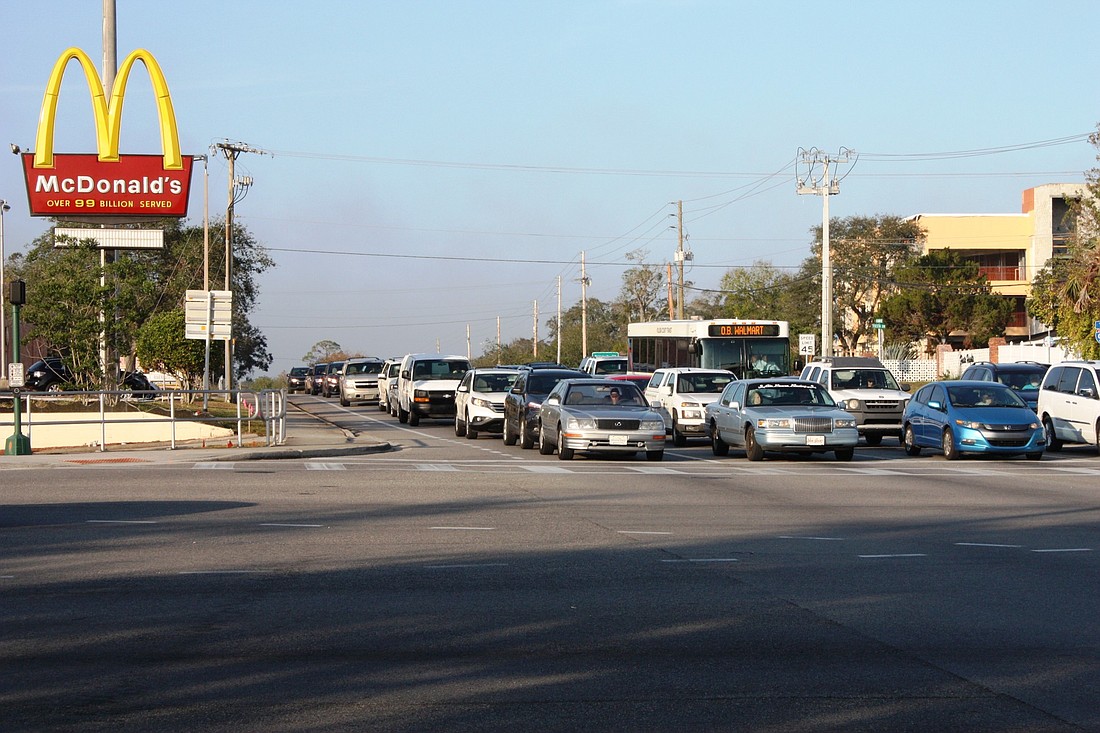 Vehicles wait at the Granada Boulevard/Nova Road intersection, which is rated F, for 'failure,' by the FDOT because of traffic backups. The rest of Granada is rated satisfactory. Photo by Wayne Grant