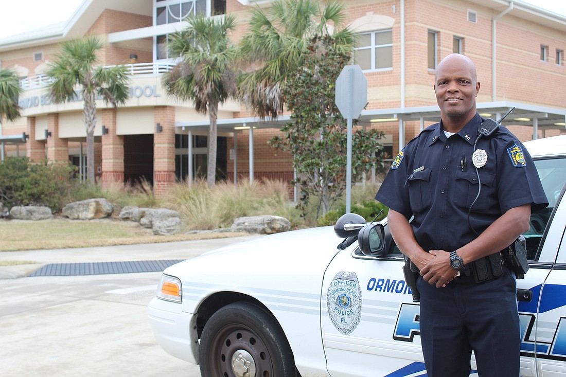 Officer Greg Stokes smiles outside his patrol car station at Ormond Beach Middle School. Photo by Jarleene Almenas