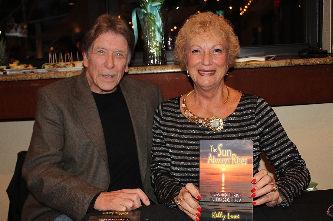 Gary Broughman and Kelly Lowe at her book launch for "The Sun Always Rises" at Lulu's Oceanside Grill on Wednesday, Jan. 31. Photo by Jarleene Almenas