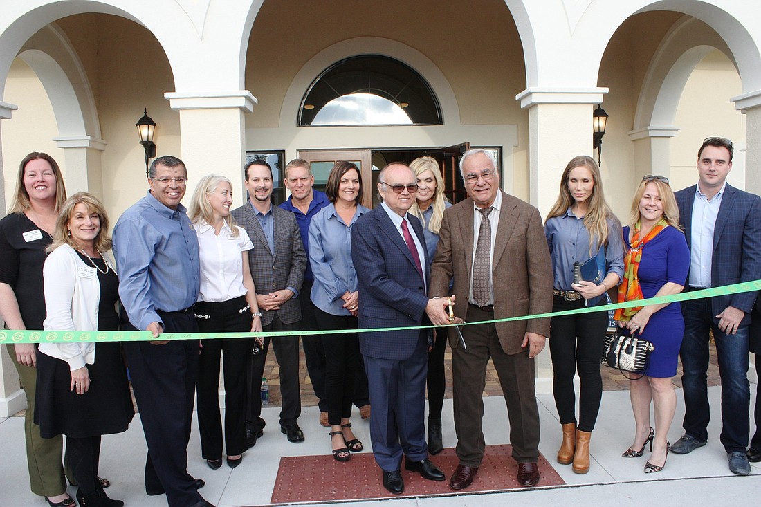 George and Josif Atanasoski cut the ribbon at the clubhouse for their Ormond Renaissance Condominiums. Photo by Wayne Grant