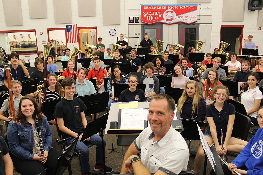 Band Director Jarrod Koskoski smiles with his students during an after school rehearsal on Feb. 13. Photo by Jarleene Almenas