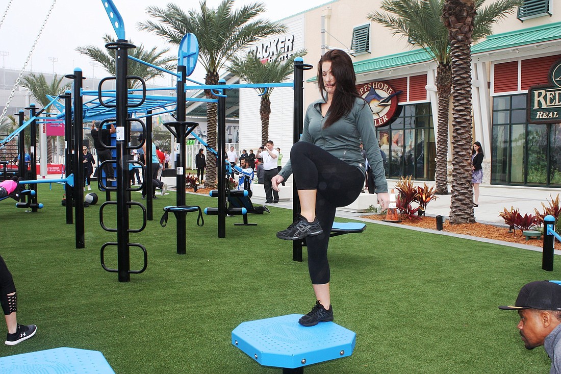 Mallory Luchowski, wellness supervisor at Florida Hospital Memorial Medical Center, tries out the new Fit Park at One Daytona. Photo by Wayne Grant