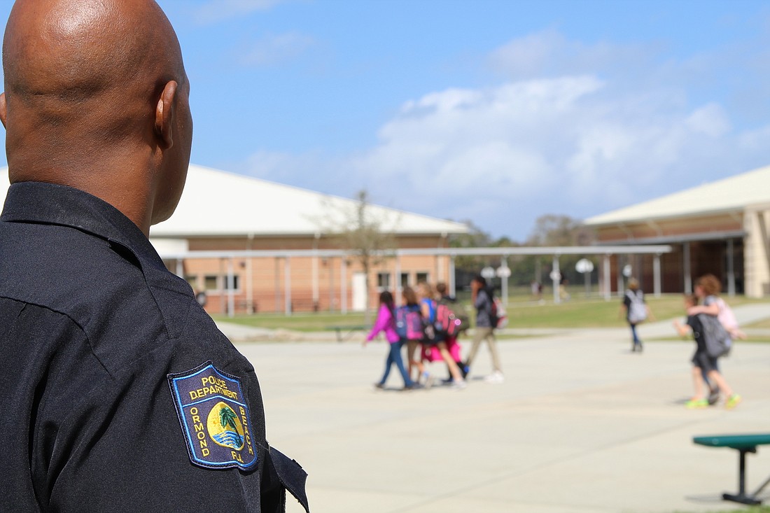 Officer Greg Stokes oversees the lunch change at Ormond Beach Middle School. Photo by Jarleene Almenas