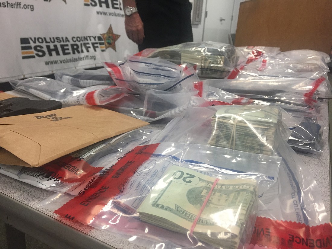 A firearm, 15,000 doses of heroin and an undetermined amount of cash was seized during "Operation Heavyweight" on Tuesday, March 13. Photo by Jarleene Almenas