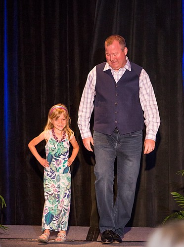 John Mark Adkison, Embry-Riddle Aeronautical University's assistant athletic director, and his daughter, Georgia Grace Adkison, 5, walk the runway to raise money for pediatric care. Courtesy photo