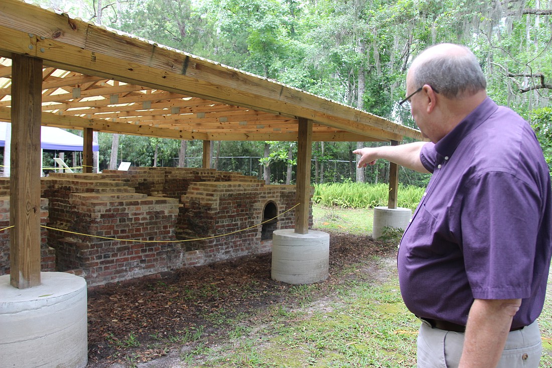 Dr. Philip Shapiro points at the boilers at the Three Chimneys Sugar Mill site which was used for the production of molasses, sugar and rum. Photo by Jarleene Almenas