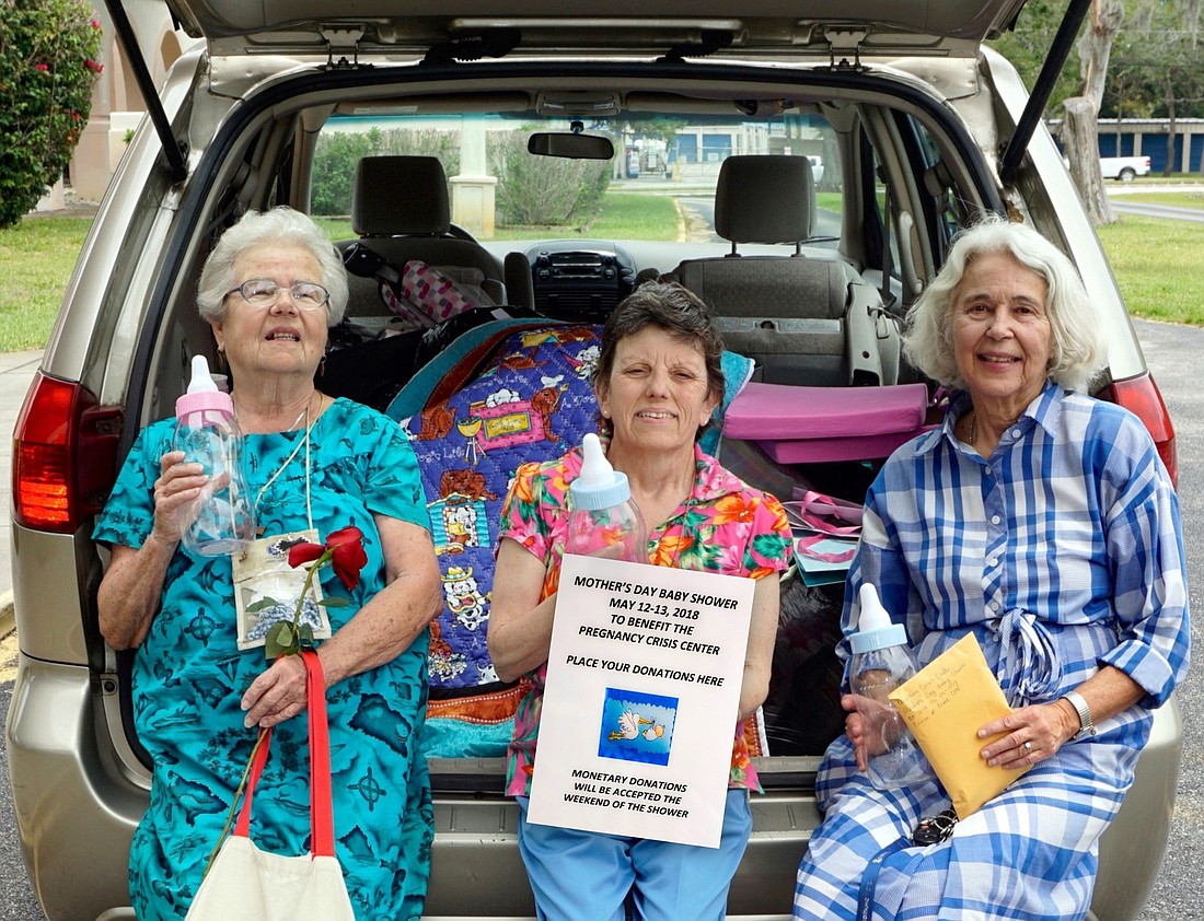 Louise Trudel, Marcia Rudman and Patti Ann Welter deliver items from the Prince of Peace Council of Catholic Women's Mother's Day Baby Shower to the pregnancy crisis center. Courtesy photo
