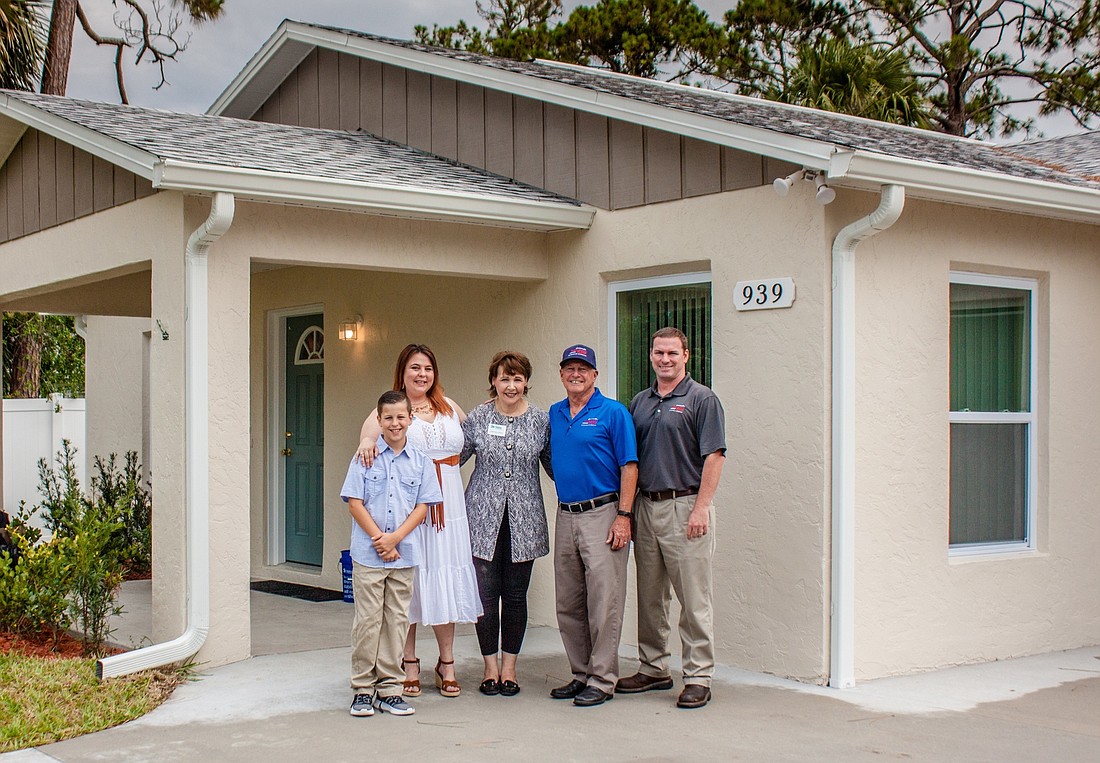 Danielle LeBlanc and her son, Andrew, stand outside their Habitat for Humanity home along with Lori Gillooly, CEO of Habitat for Humanity and Bill Thompson and Chris Thompson, of Thompson Pump. Photo courtesy Kimberly Boyce
