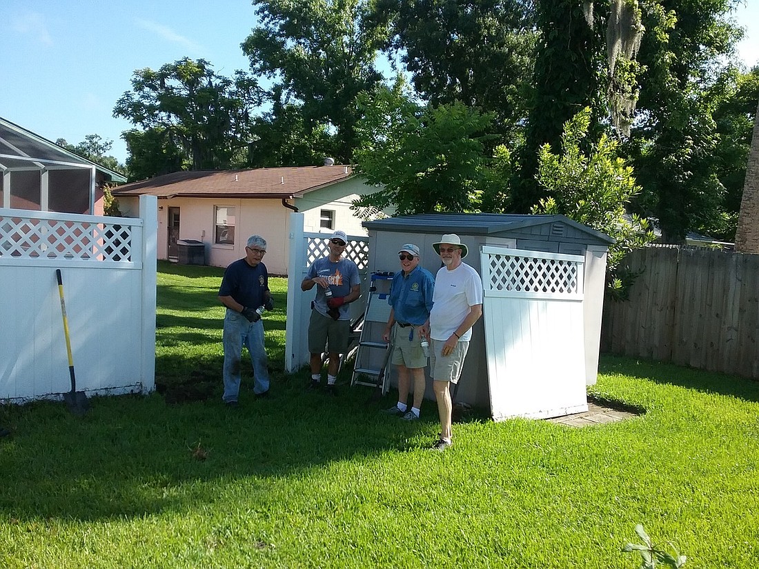 Rotarians help fix a 92-year-old widow's fence in Ormond Beach. Courtesy photo