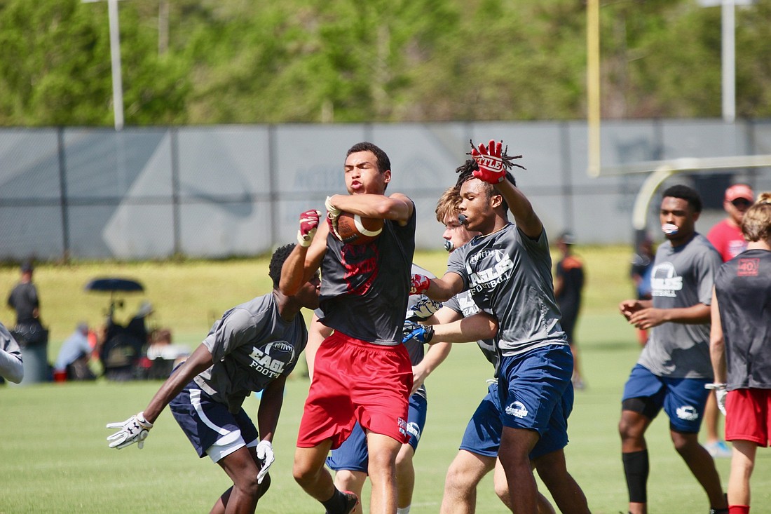 Seabreeze receiver Orion Mountain dodges a defender at UCF's 7-on-7 camp. Photo by Ray Boone
