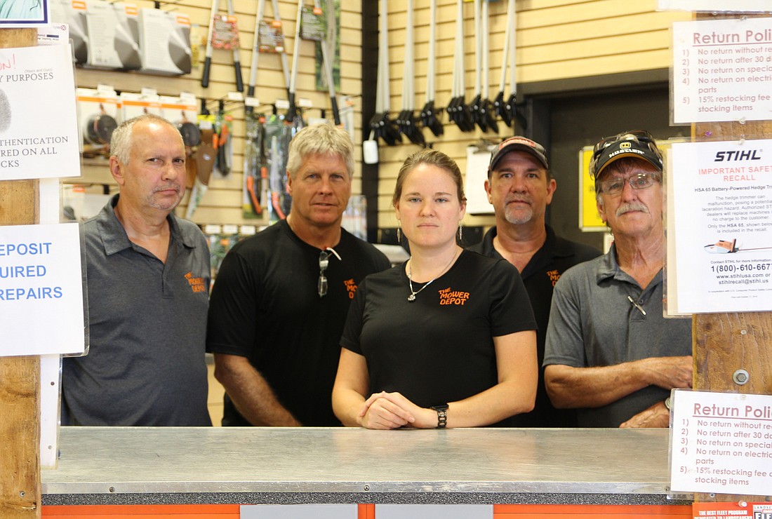 The staff at Mower Depot, Dennis Lloyd, Owner Scott Edwards, Brandy Snyder, Ralph Coates and Car Collier, are standing up to raise awareness of outdoor power business burglaries and larcenies. Photo by Jarleene Almenas