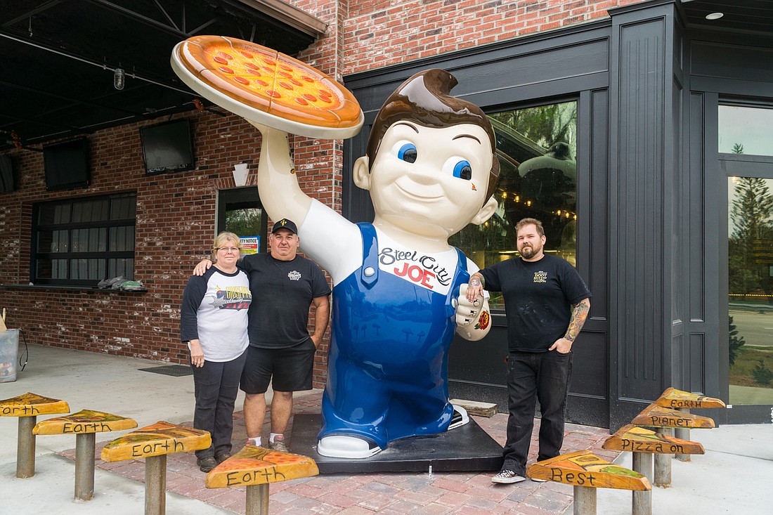 Julie, Joe, and JoJo Mialki standing in front of their hand-painted Big Boy in front of their new restaurant. Photo by Zach Fedewa