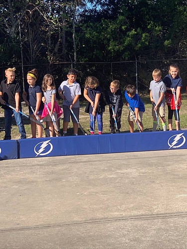 Port Orange Elementary students learn hockey skills from the Tampa Bay Lightning team. Courtesy photo