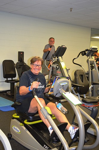 Jane Weber, of Ormond by the Sea, and Adam Tominsky, of Daytona Beach, work out at the Ormond Beach YMCA recently. Photo by Wayne Grant