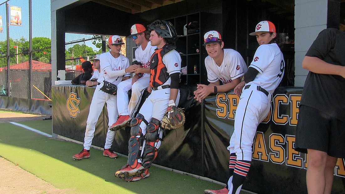 Evan Mastromauro (Sr. #9) and the crew are all smiles in the Spruce Creek dugout. Photos by Chuck Dubois