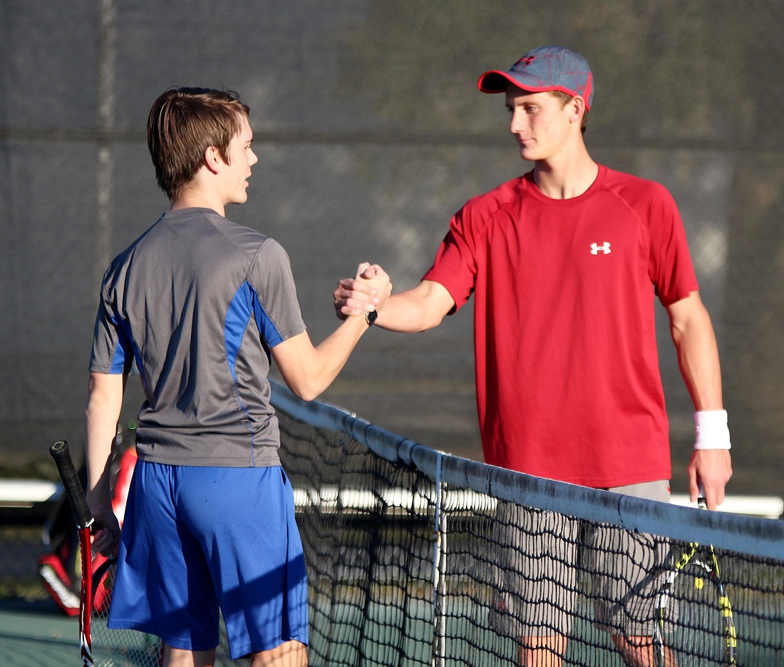 Will Greaves and Bucs' Gus Deberri shake hands after their doubles match.