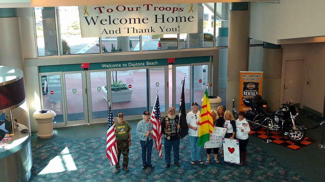 Members of Ormond Strong welcome returning servicemen at Dayona Beach International Airport recently. The group recently spoke to the County Council about honoring Vietnam veterans.Courtesy photo