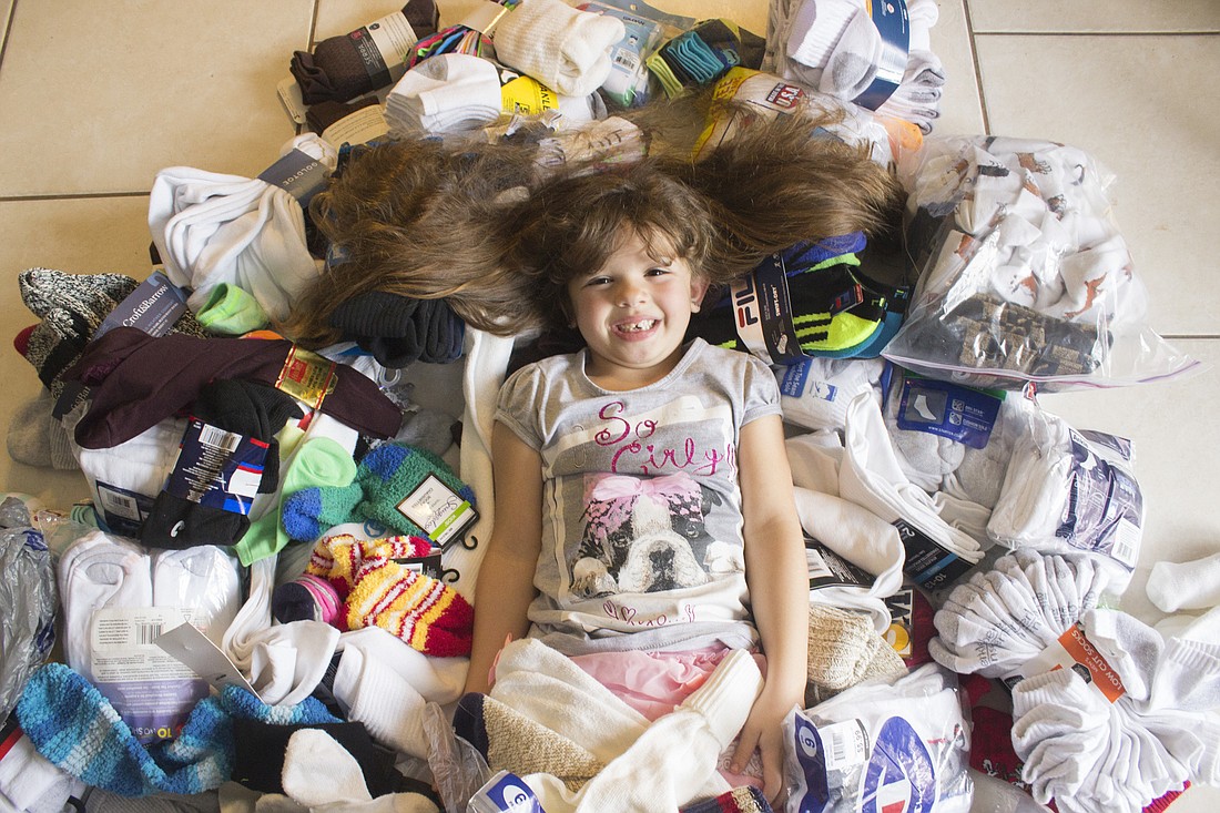 Leah Davis surrounded by her current sock donation (Photo by Emily Blackwood).