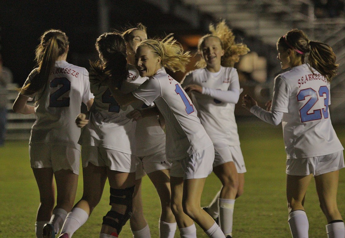 The Lady Sandcrabs celebrate one of their goals this season. Photo by Jeff Dawsey