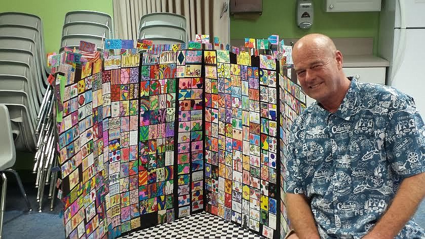 Wendell Fuller with his students' artist trading cards (Courtesy photo)