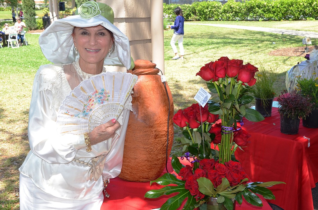 Dotti Rubino, of Palm Coast, enjoys the roses that were donated by the The Flower Market, Ormond Beach.