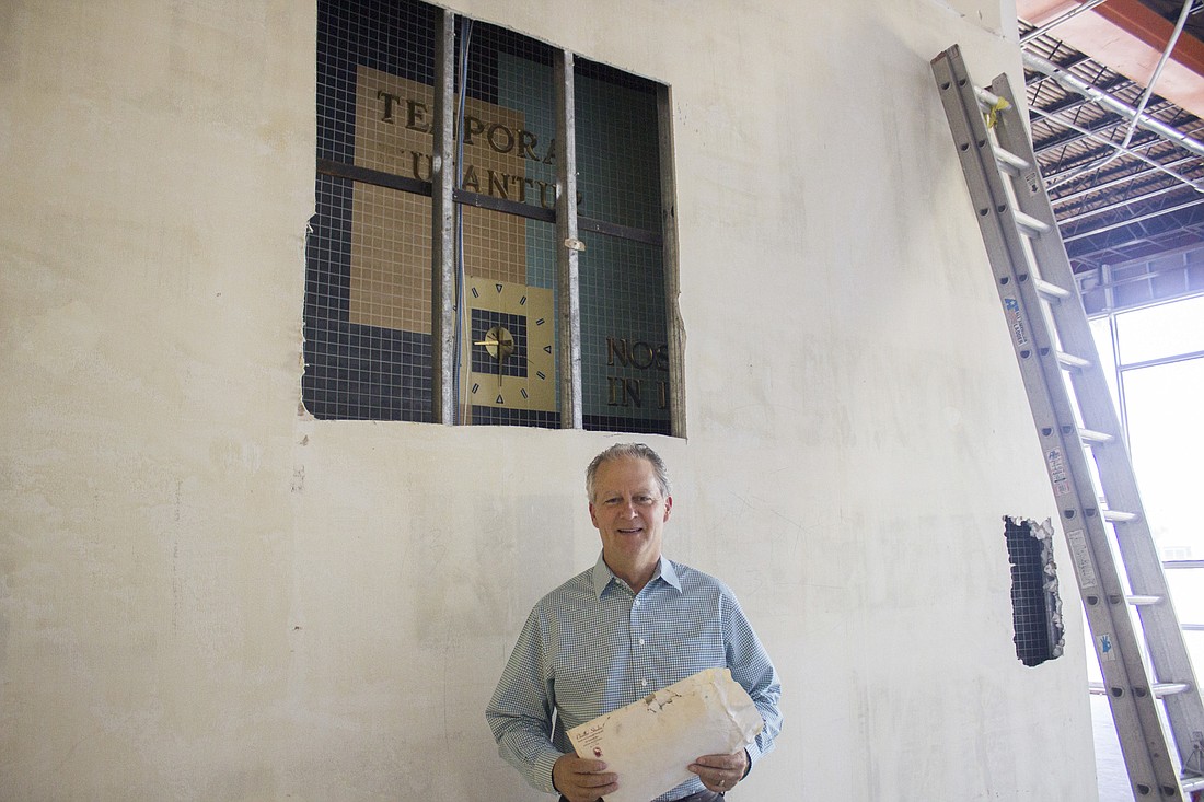 Dwight Selby of Selby Realty with one the discoveries made during his company's renovations (Photo by Emily Blackwood).