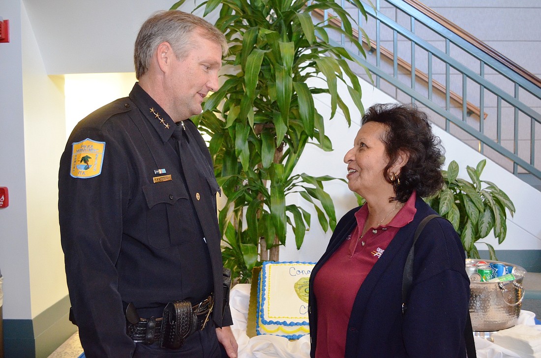 Chief Jesse Godfrey talks with Juanita Garza, records clerk, at a reception in his honor April 19.Photo by Wayne Grant