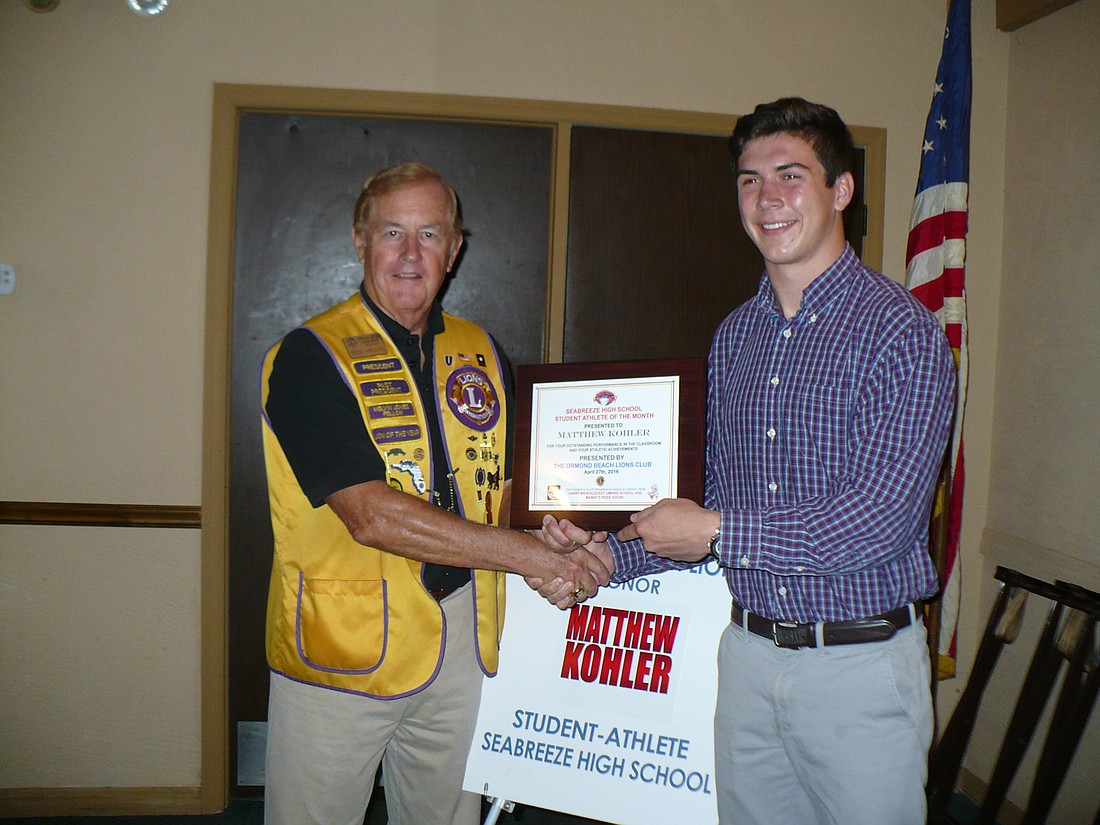 Tom Millen presents the Student-Athlete of the Month Award to Matt Kohler.