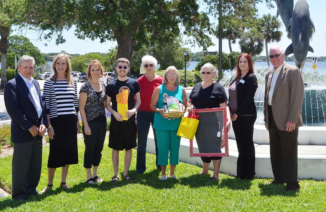 Officials and scavenger hunt winners shown are Joe Mannarino, economic development director; Debbie Berner, of River Grille; Terri Francis and her son, Cameron; Claudia Malo; Karen Todd; Sandy Smith; Crystal Hurst, of State Farm; and Rick Fraser, executiv