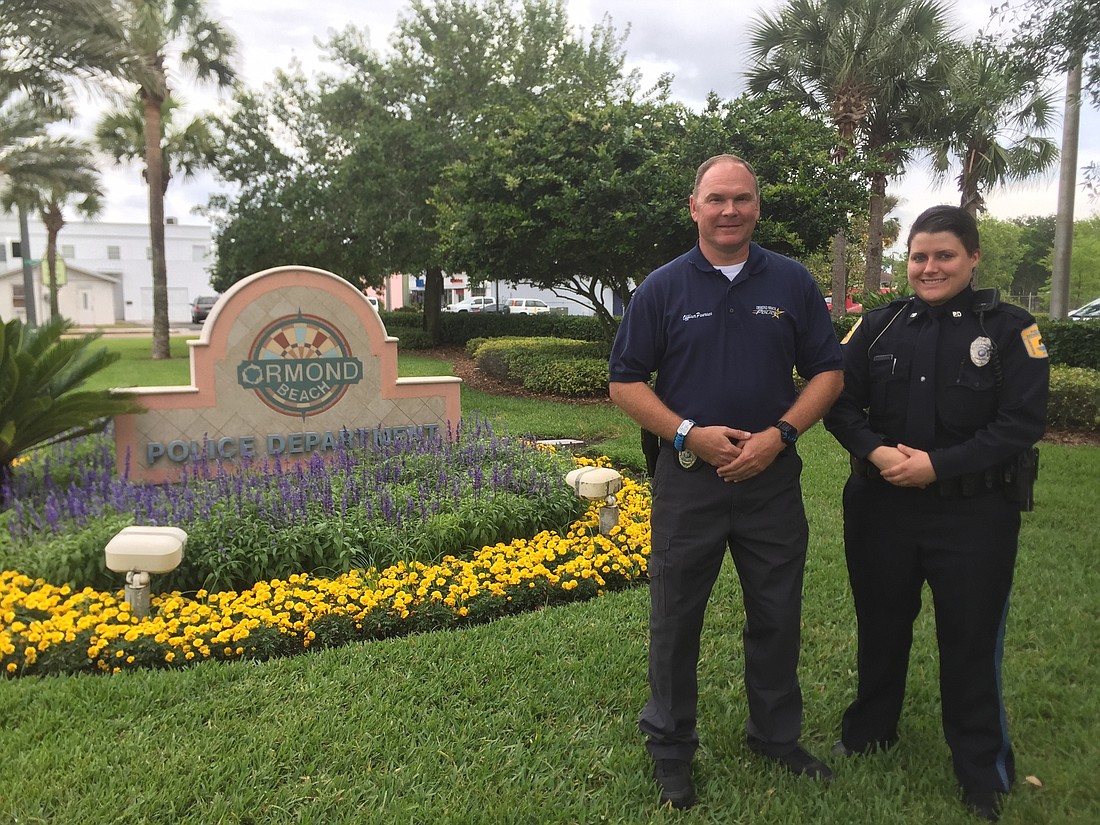 Officer Lauren Sanders with one of her Police Explorer mentors, Sergeant Steve Mills (Photo by Emily Blackwood).