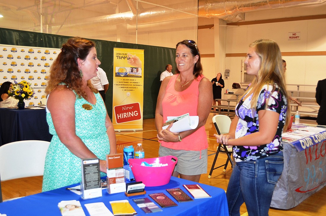 Shannon Benes, Human Resources director at Parks Dermatology, talks with Susan Ward and Ashley Yelvington, who is graduating from Seabreeze High School.Photo by Wayne Grant