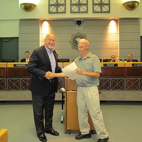 Mayor Ed Kelley congratulates Russ Royce for his work with the Community Garden.