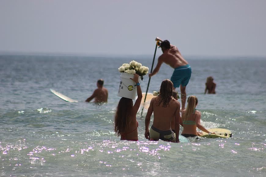 Friends and family took flowers and sprinkled them out into the ocean in honor of someone they never want to forget (Photo by Cameron Hanrahan).