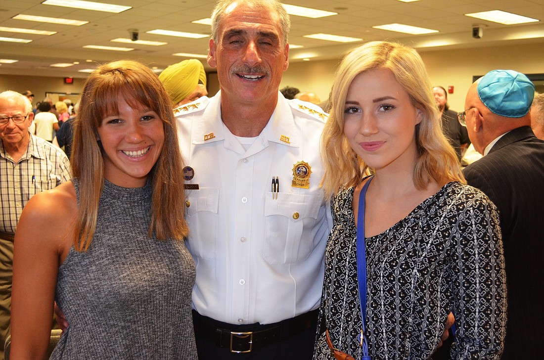 Regan Creamer (right), of Atlantic High School, suggested the idea for an interfaith community vigil to Police Chief Mike Chitwood. At left is Regan's friend, April O'Gorman, of New Smyrna Beach High School.Photos by Wayne Grant