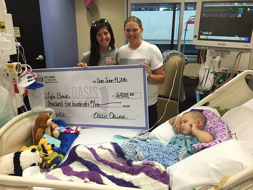 Meagan Scharmahorn, kids director at Oasis Church, recently presented the check to the Bear family (Courtesy photo).