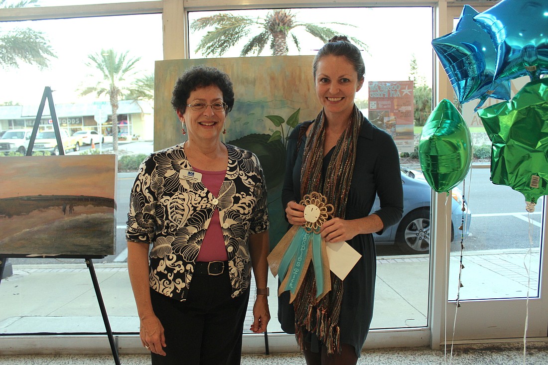 Ormond Mainstreet Executive Director Julia Truilo presented the award to Kristin Heron. The prize ribbon was made by Georgia Johnson (Photo by Emily Blackwood).