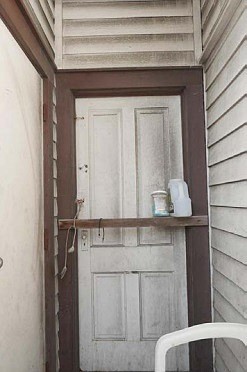 This door that leads to a basement was boarded up until recently.