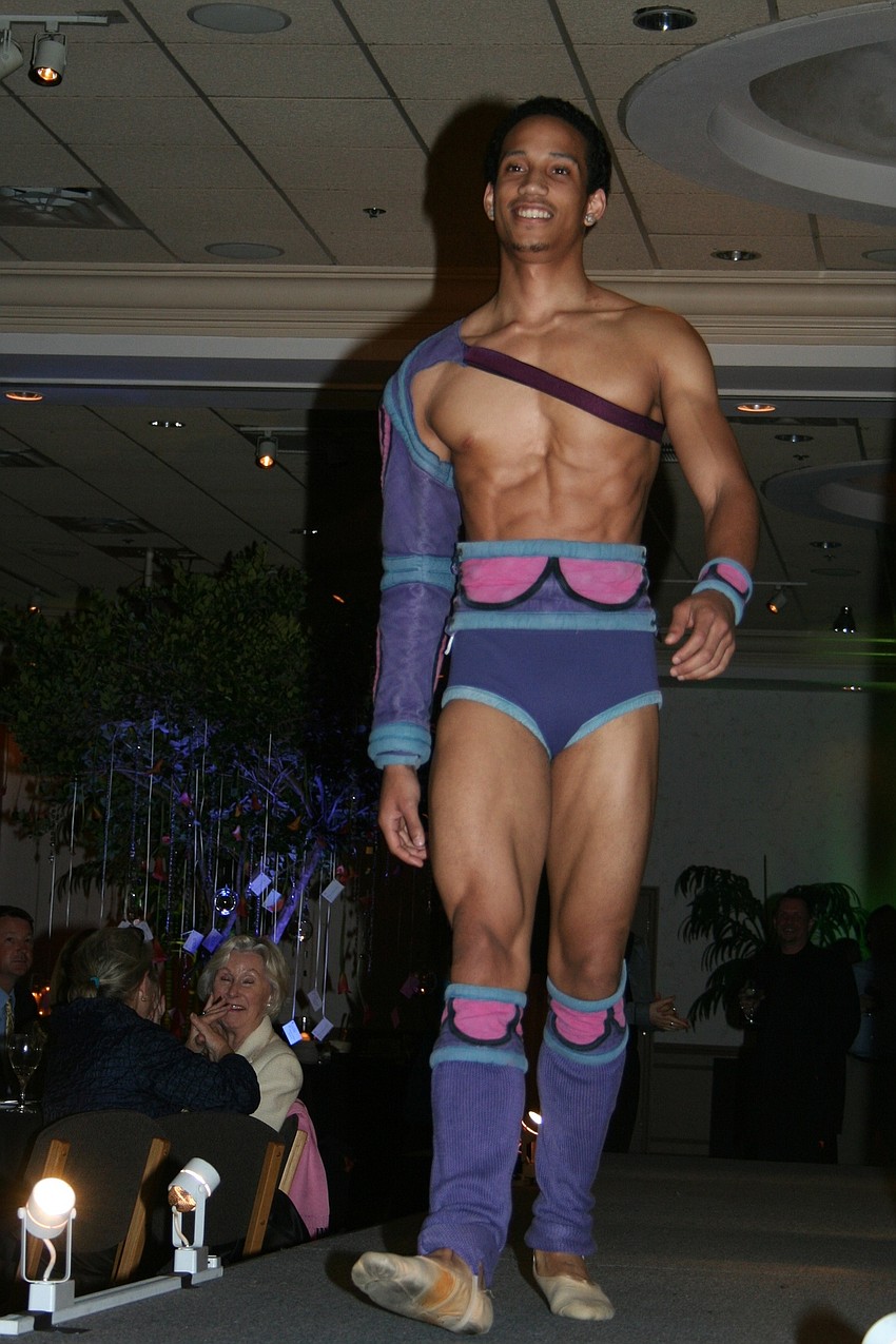 Dancers modeled costumes in a runway fashion show