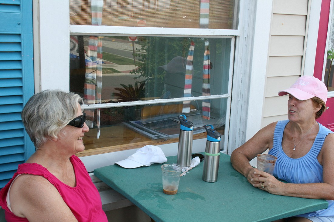 Sisters Carolyn Taylor and Kathy McKean drink coffee at the soon-to-be former location of BeachHouse Beanery.
