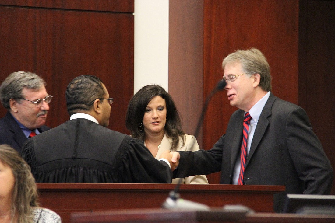 Steven Alexander, the attorney representing Jamesine Fischer, speaks with Circuit Judge Raul Zambrano and prosecuting attorneys Wednesday.