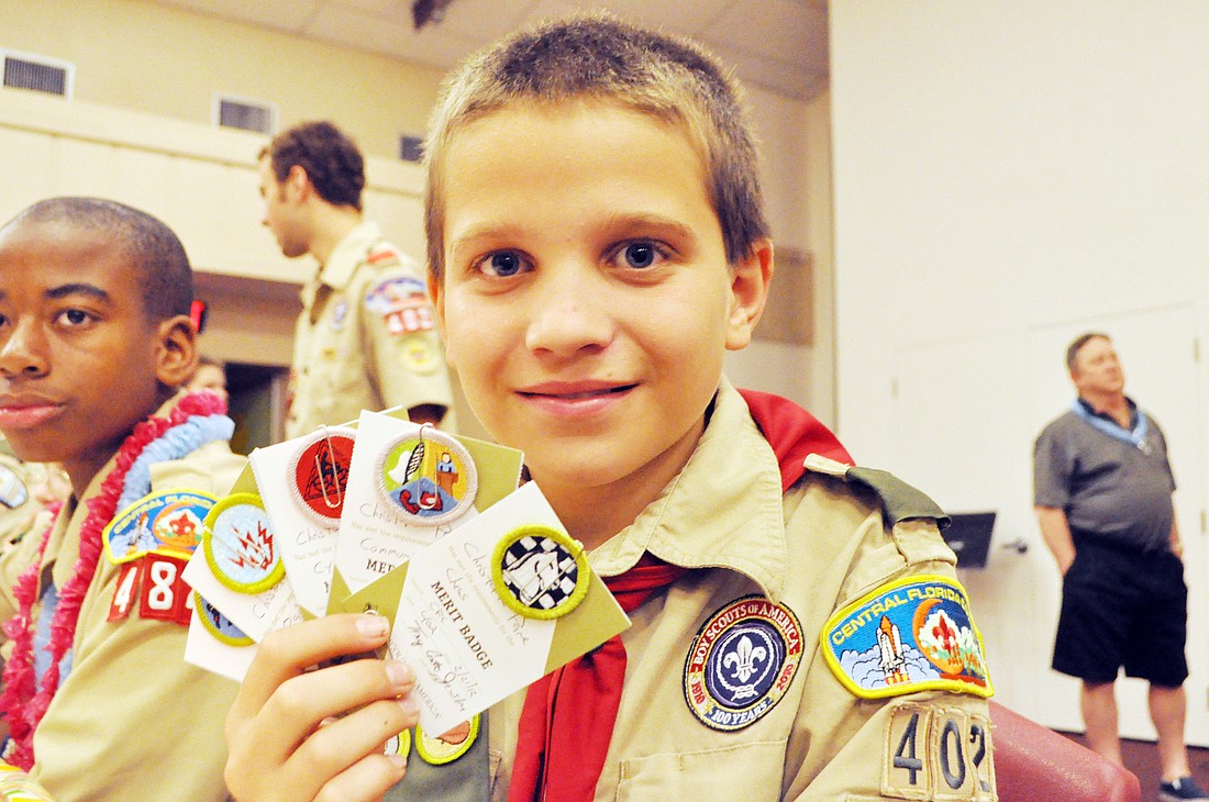 Christopher Pane earned five merit badges at the ceremony: radio, cycling, chess, communication and snow sports.