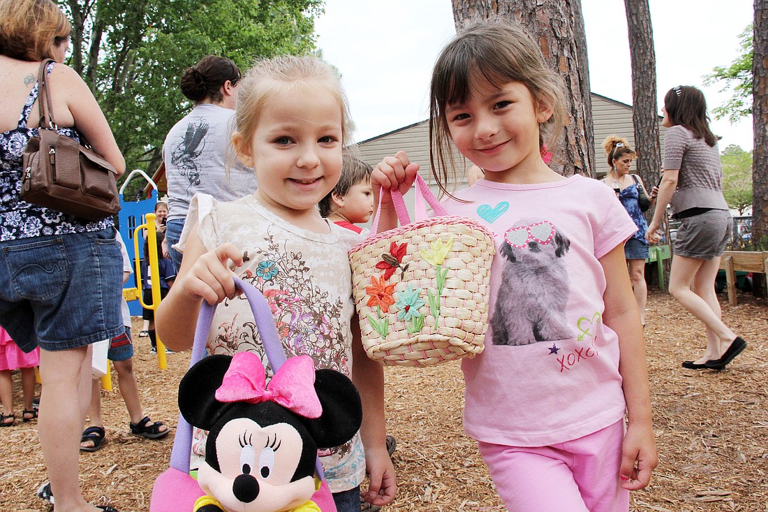 Kayleigh Phillips and Teagan Newbolt show off their full baskets after the Easter egg hunt.