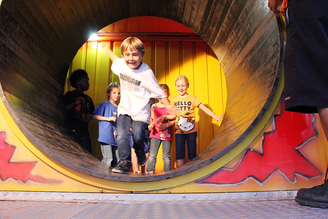 Gene Battarack leads the way through the revolving barrel at the fun house exit, Wednesday, April 4, at the Flagler County Fair and Youth Show.