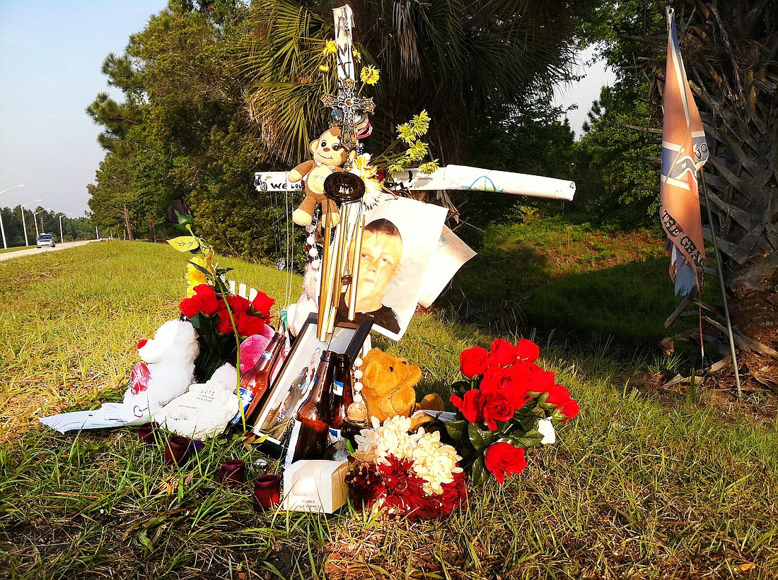 A memorial for Anthony Rogers has been set up on Matanzas Woods Parkway. PHOTO BY BRIAN MCMILLAN