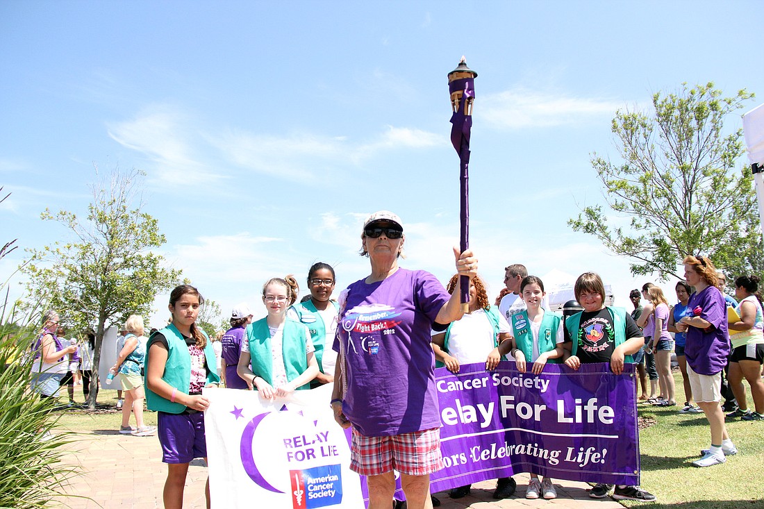 Laverne Smith, a seven-year survivor, carried the torch for the inaugural survivor lap.