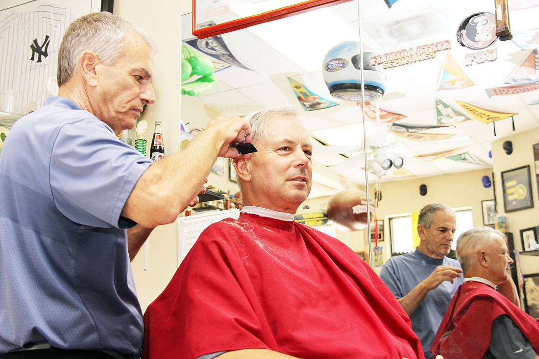 Terry Conley, owner of TerryÃ¢â‚¬â„¢s, attends to Bill Susetka, a customer for seven years.