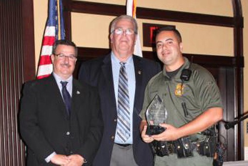 Chief Deputy David OÃ¢â‚¬â„¢Brien and Sheriff Donald W. Fleming congratulate Sgt. Phil Reynolds on his award.