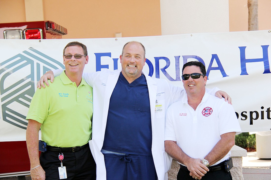 Palm Coast Fire Chief Mike Beadle, Dr. Andrew Coleman, and Flagler County Fire Chief Don Petito