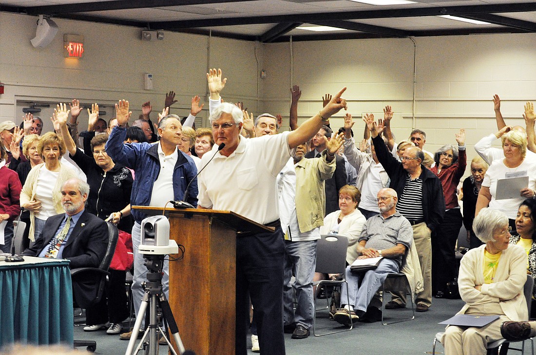 Tom Lawrence is pictured at the lectern in 2011, when he and other Grand Haven residents first opposed the stormwater fee. FILE PHOTO BY BRIAN MCMILLAN