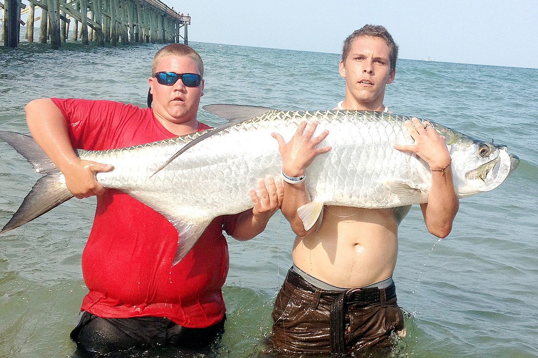 Kyle Heffner (left) and Nick Kennerly after catching an 80-pound tarpon last week off the Flagler Beach Pier.